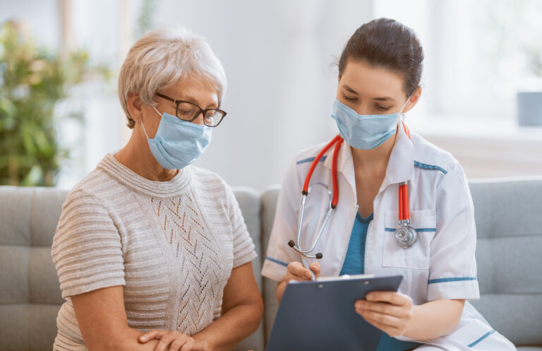 doctor and senior woman wearing facemasks